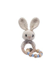 Handmade crochet blue rabbit rattle with chain and natural wooden ring, a sensory newborn baby toy perfect for baby shower gifts and nursery essentials.
