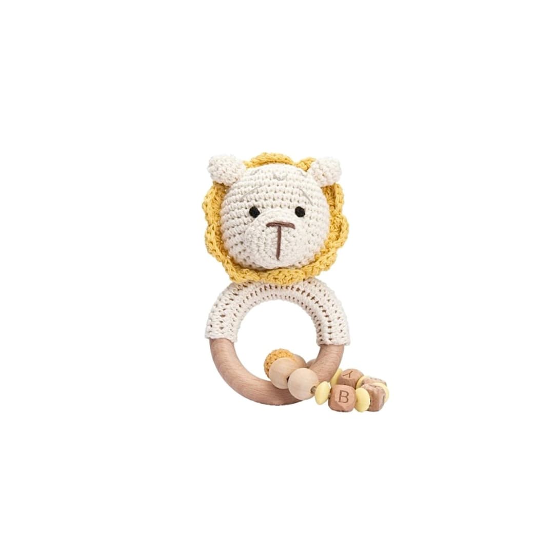 Handmade crochet lion rattle with chain and natural wooden ring, a sensory newborn baby toy perfect for baby shower gifts and nursery essentials.