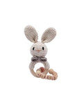 Handmade crochet rabbit rattle with chain and natural wooden ring, a sensory newborn baby toy perfect for baby shower gifts and nursery essentials.