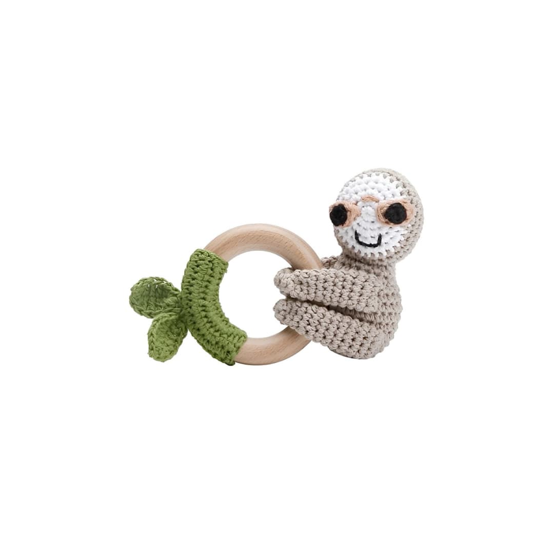 Handcrafted crochet sloth rattle with natural wooden ring, a soft sensory toy for newborn babies and a thoughtful baby shower gift.