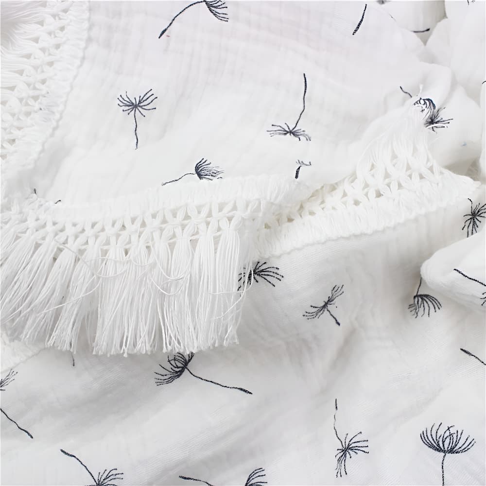 Close-up of dandelion pattern cotton baby blanket, soft breathable newborn blanket made from gentle cotton fabric.