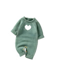 Dark green knitted baby romper with white heart pattern and button closure for easy diaper change