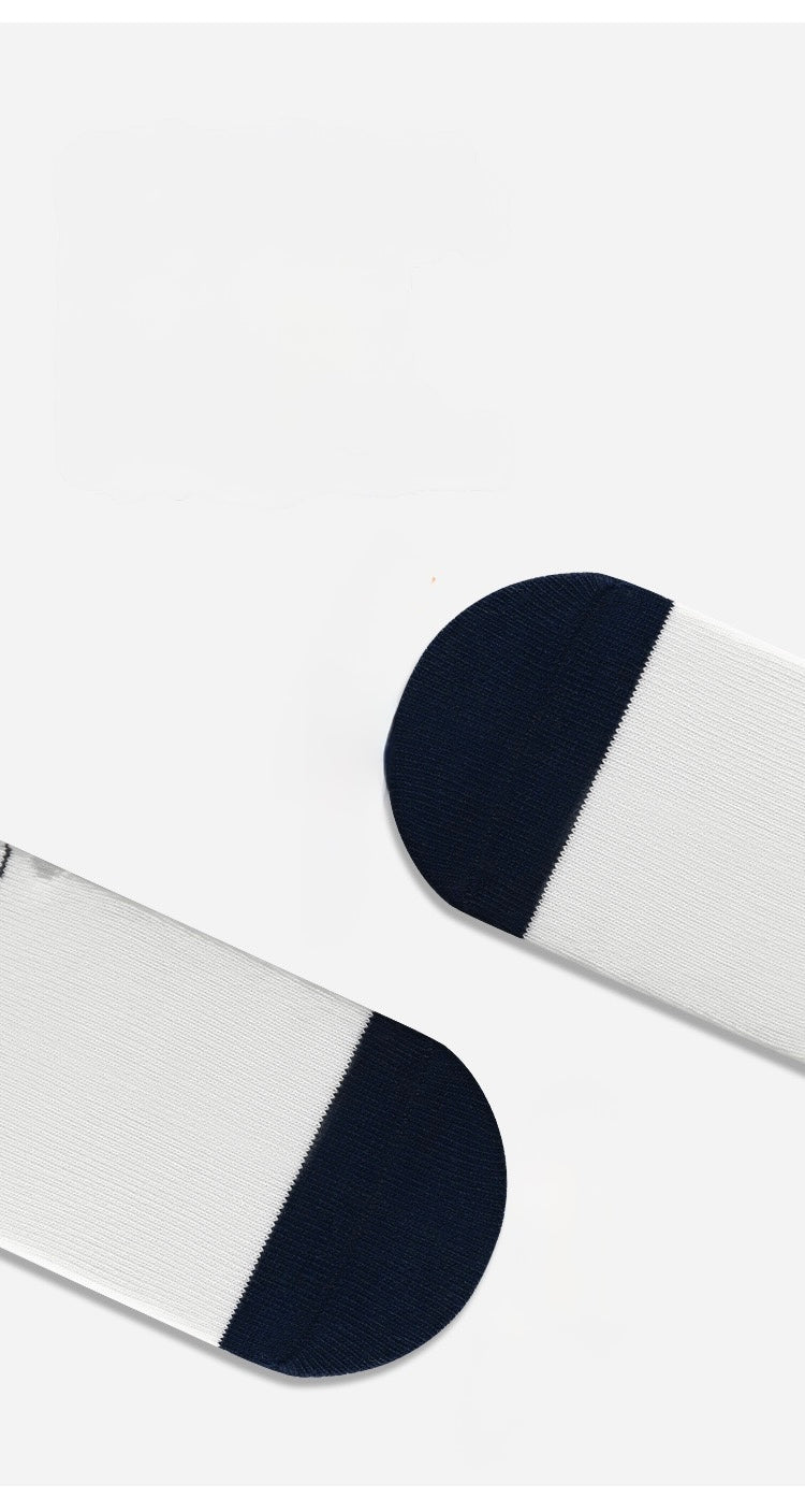 White baby socks with embroidered bear detail and navy cuff