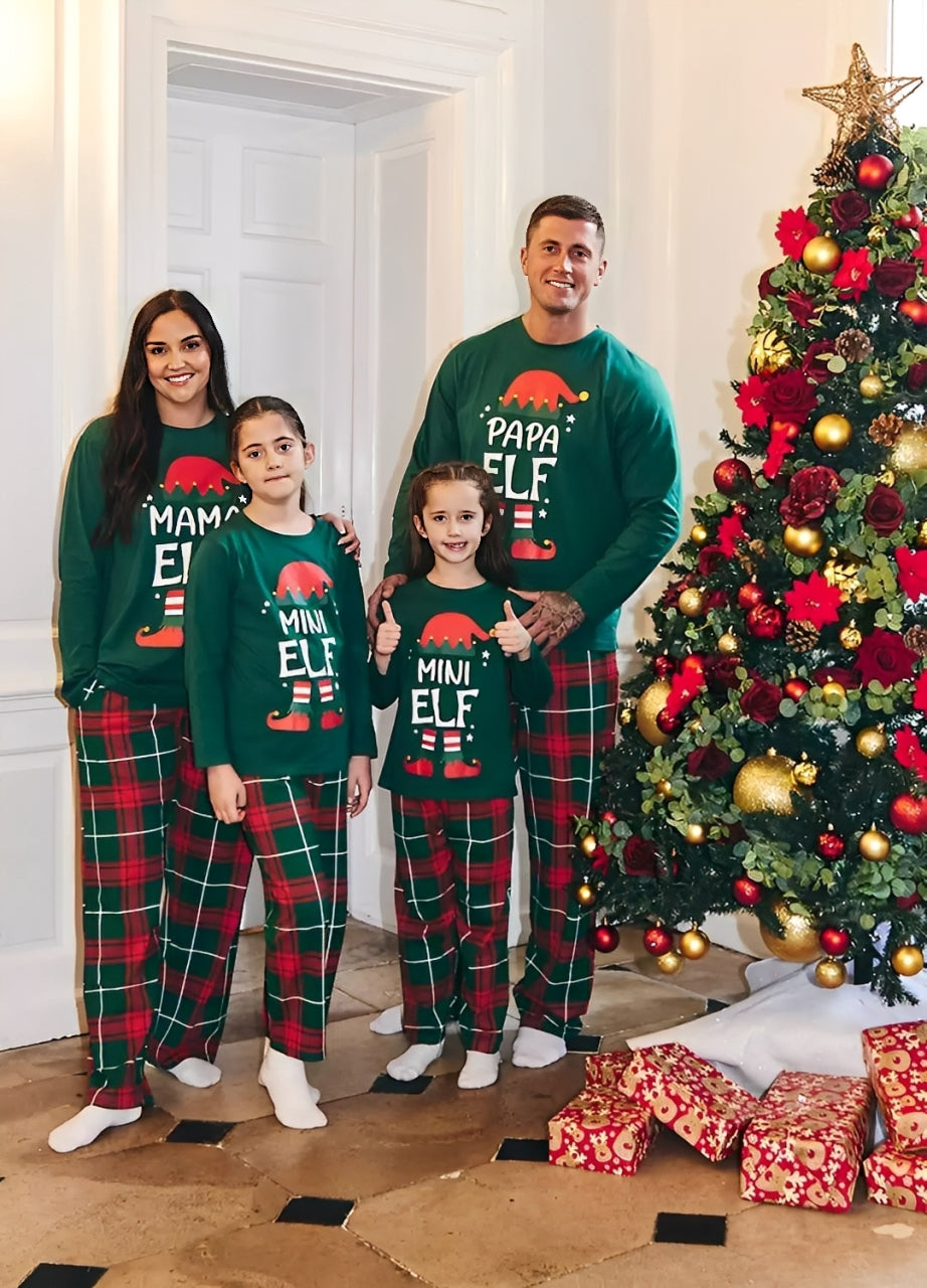 Family matching Christmas elf pajamas set with green tops and red plaid pants, holiday photo by Christmas tree
