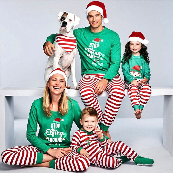 Family wearing matching Christmas pajamas with green tops and red white striped pants, holiday loungewear set