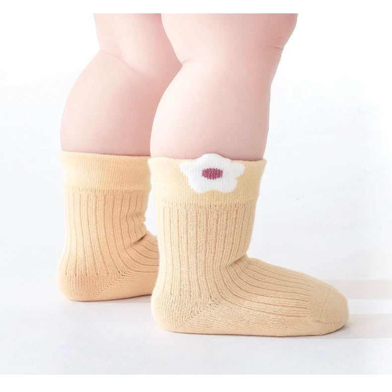 Close-up of floral embroidery detail on cotton baby socks in pastel mix