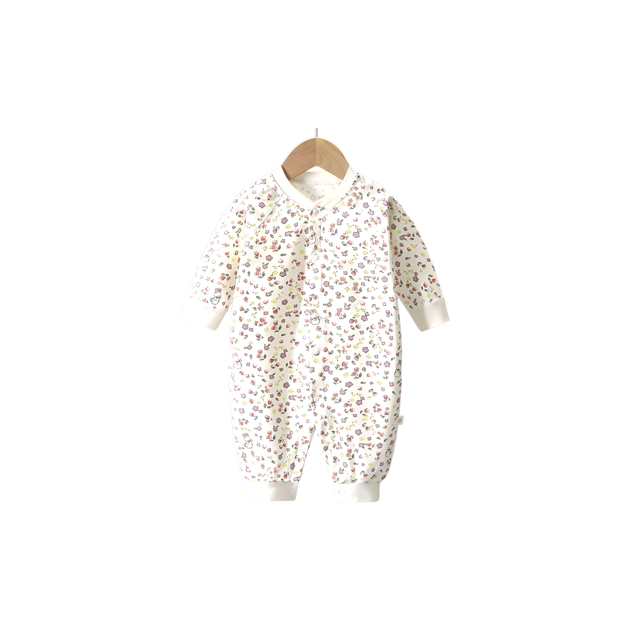White cotton baby romper with all-over floral print, long sleeves, and snap-button closure hanging on wooden hanger
