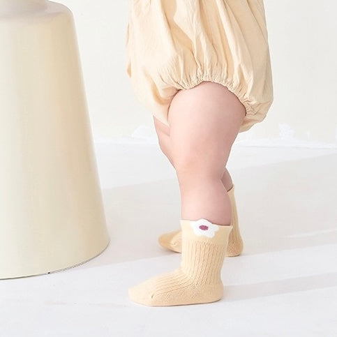 Baby wearing beige floral cotton socks – soft pastel baby socks for everyday wear