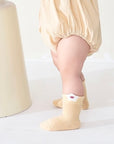 Baby wearing beige floral cotton socks – soft pastel baby socks for everyday wear