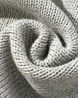 Close-up of gray cable knit fabric texture, showcasing thick soft cotton weave for baby romper.