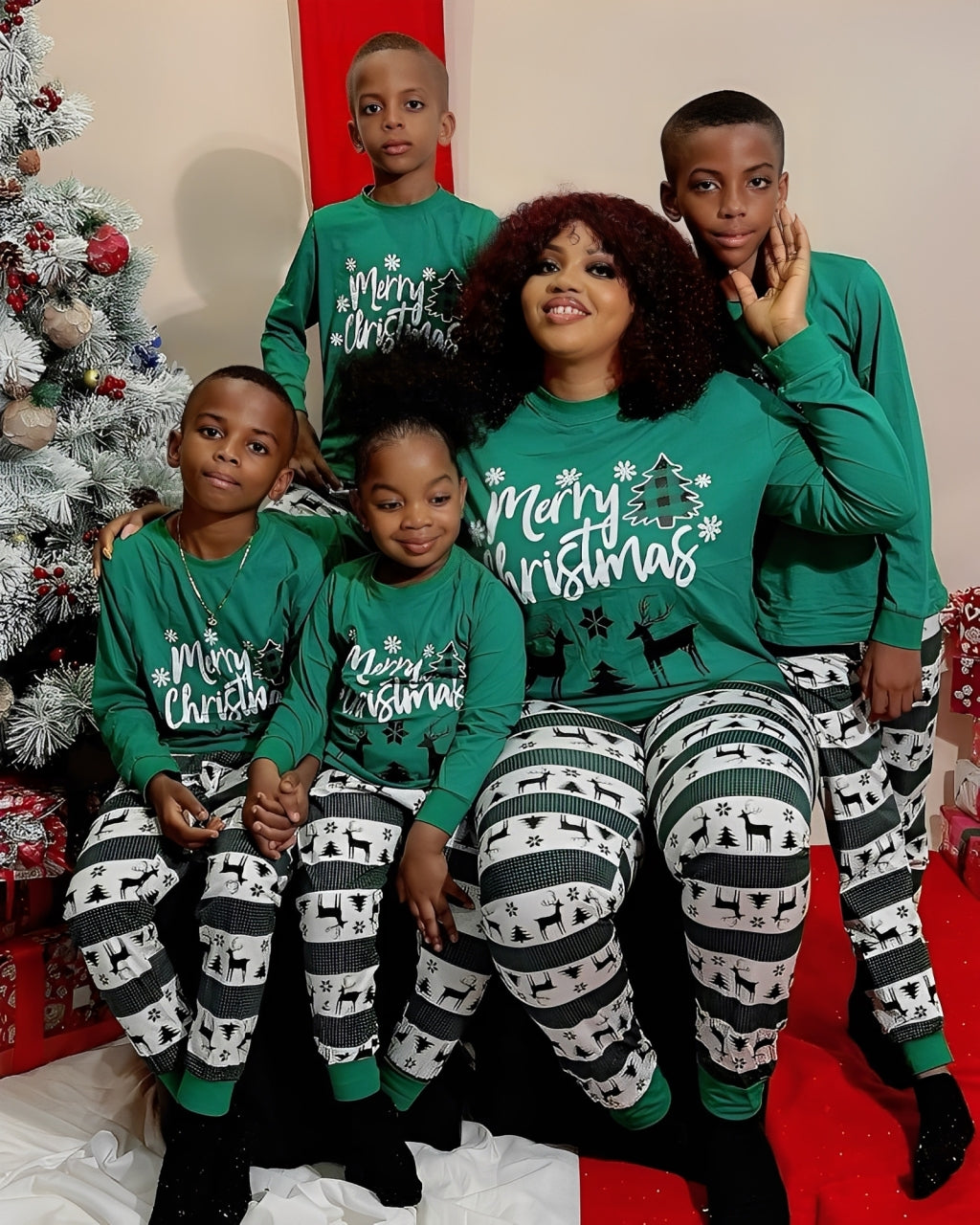 Family Christmas photo in matching green Merry Christmas pajamas with festive print