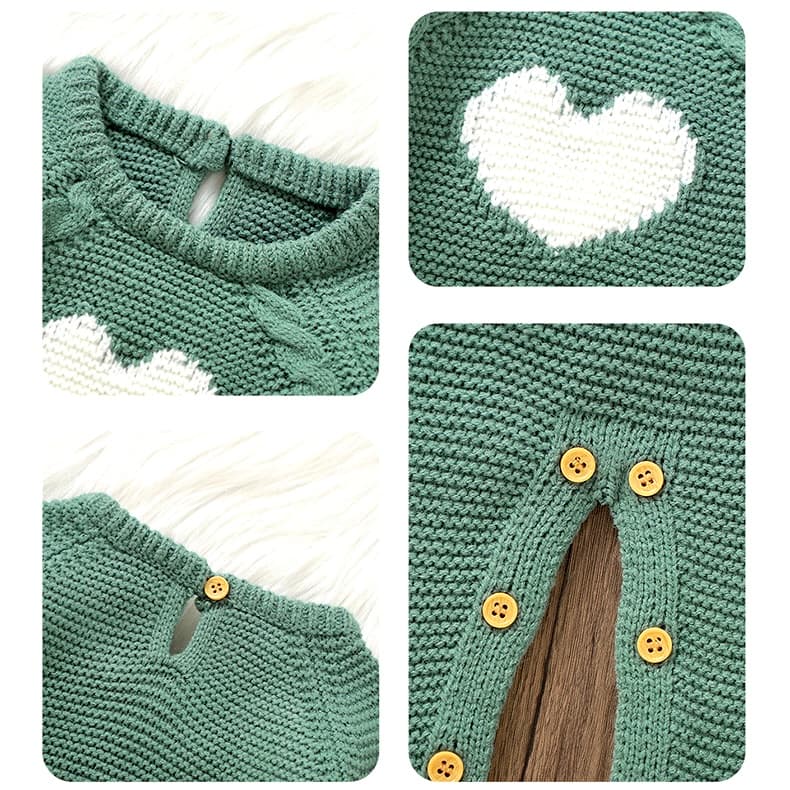 Close-up of heart embroidery and button details on dark green knitted baby romper
