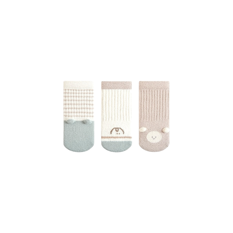 Three pairs of baby socks with different patterns on a white background