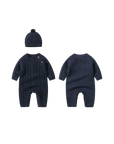 Navy blue cable knit baby romper and hat, showing detailed front and back textured pattern.

