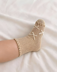 Neutral beige lace edge cotton baby socks with ribbon bow detail for babies and toddlers