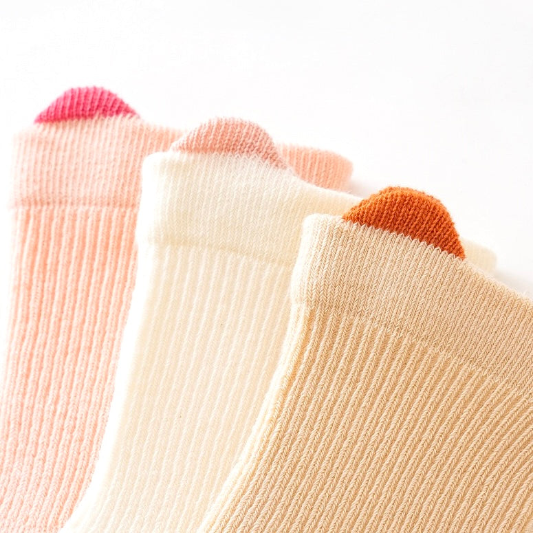 Close-up of pastel cuff detail on soft cotton baby socks