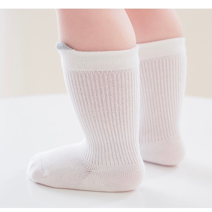 Baby wearing white pastel cotton socks – soft and breathable baby socks