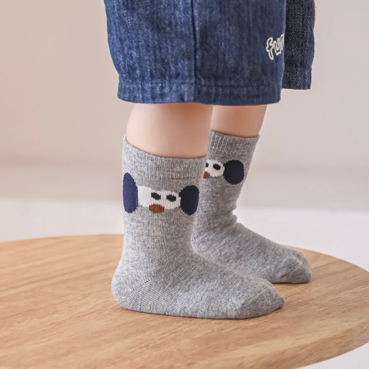 Baby wearing grey cotton socks with cute embroidered pattern – baby socks UK