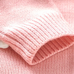 Ribbed sleeve cuff detail of pink knitted baby romper