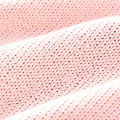 Soft cotton knit fabric texture of pink baby romper highlighting breathable material.