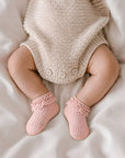 Baby wearing pink lace trim anti-slip cotton socks with soft breathable comfort for newborns and toddlers