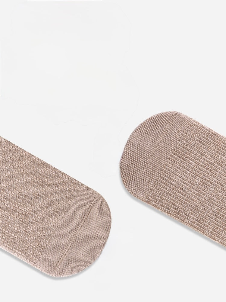 Pair of beige socks on a white background