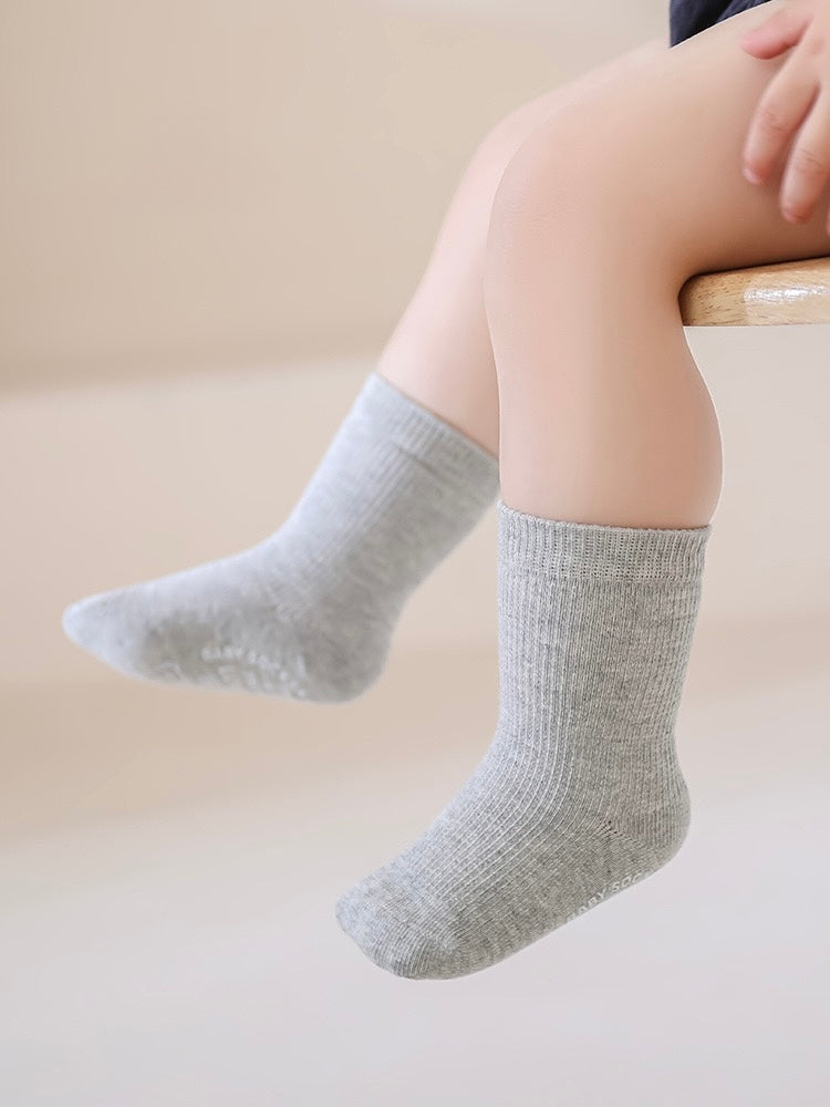Person wearing gray socks on a light background