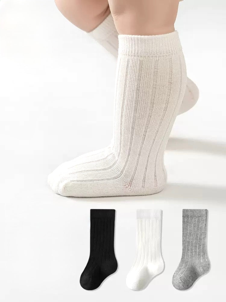 White knee-high socks with a plain background