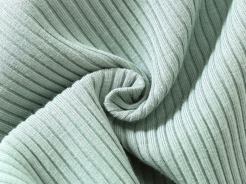 Soft ribbed cotton fabric texture used in baby jumpsuit – breathable and stretchable knit.
