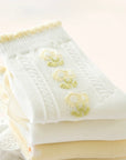 Cream floral baby socks with embroidered daisy details – soft breathable cotton socks