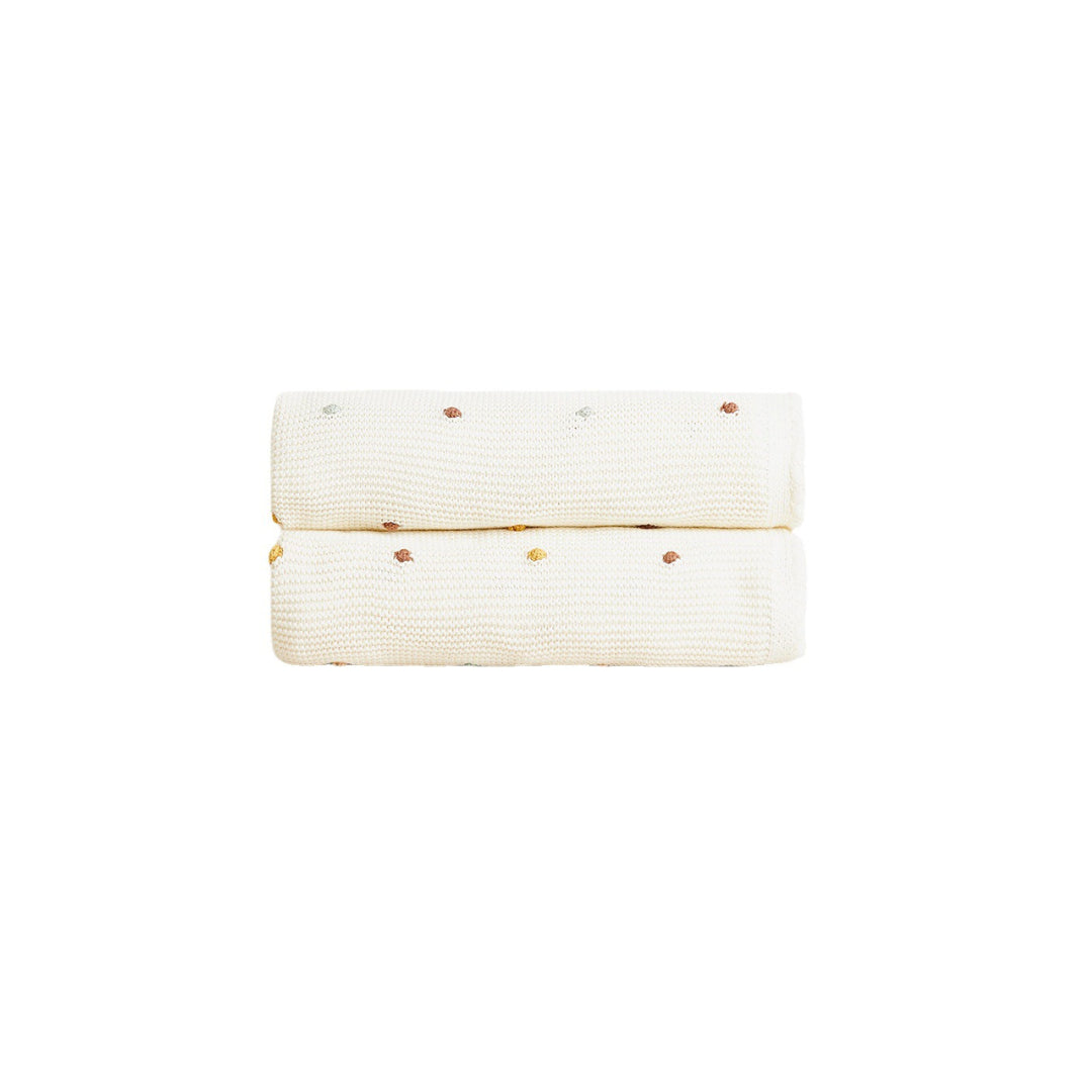 Soft spotted cotton baby blanket for newborns, breathable swaddle blanket for nursery, pram and everyday baby comfort.