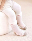 Baby model wearing striped bear baby socks – neutral tones and soft cotton design