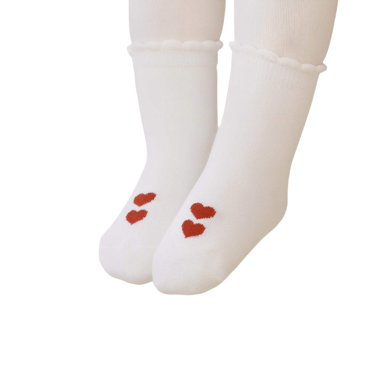 Close-up of baby wearing white cotton socks with red heart pattern