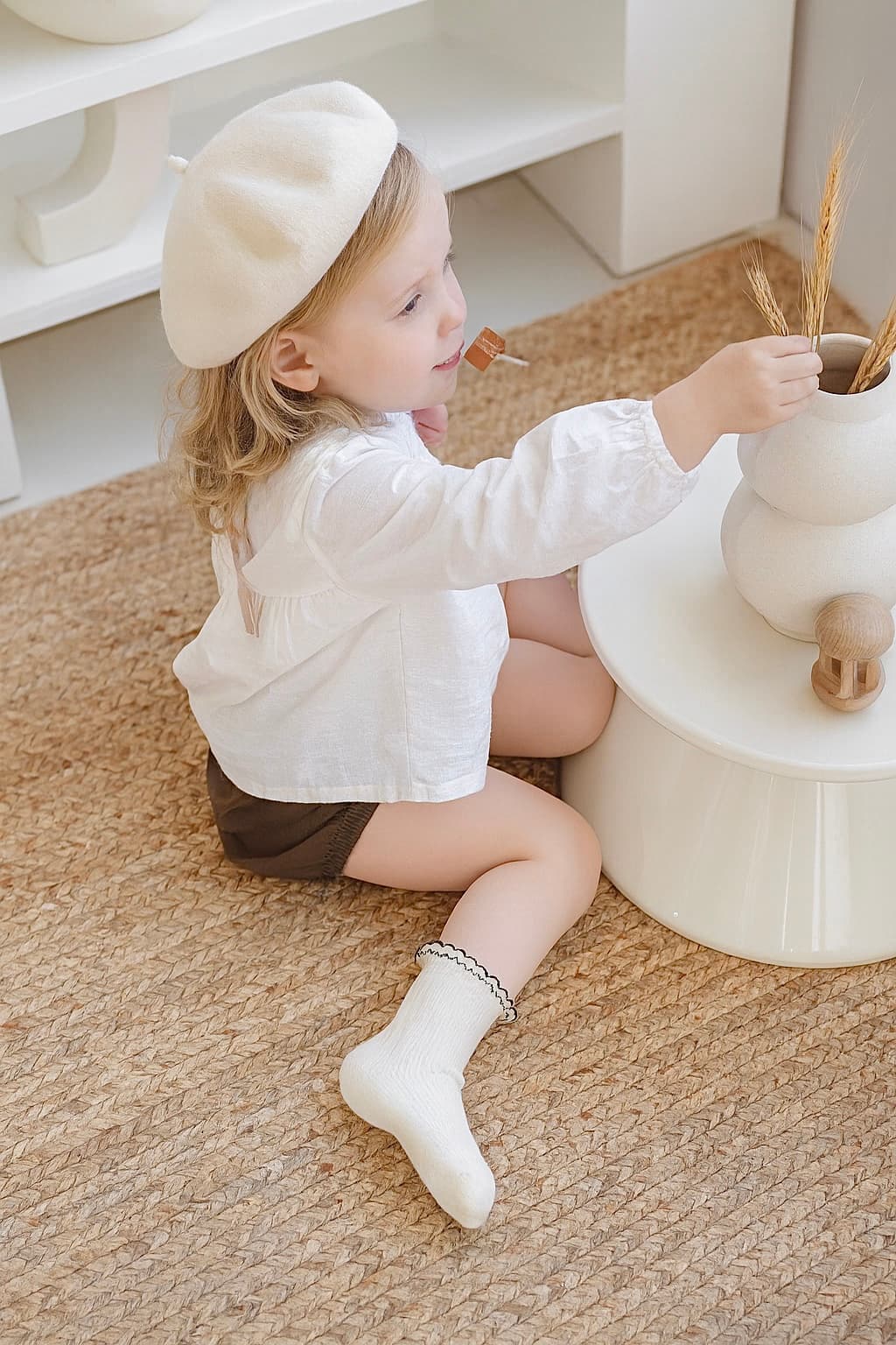 Toddler girl wearing cream cotton ruffle socks with soft non-slip sole