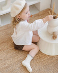 Toddler girl wearing cream cotton ruffle socks with soft non-slip sole