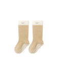 Beige baby socks with ribbed cotton texture and anti-slip sole