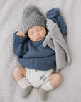 Newborn baby wearing two-tone winter knit baby socks in soft neutral cotton colours with cosy minimalist baby outfit