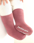 Baby wearing warm pink cotton anti-slip socks, soft and comfortable for winter
