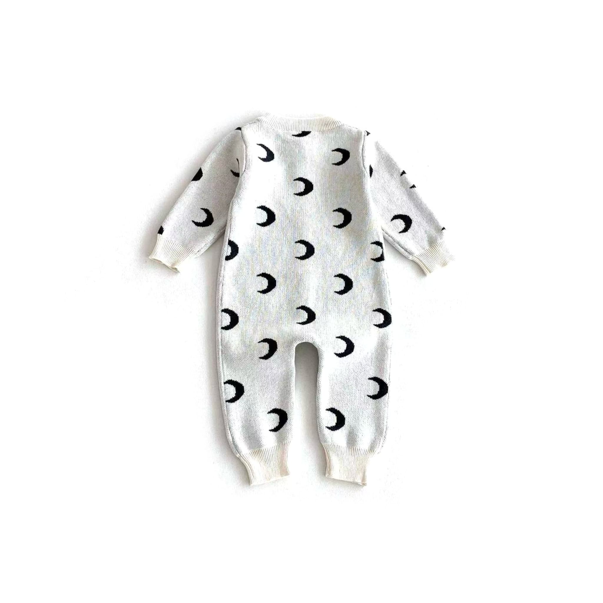 Back view of white cotton baby romper featuring black crescent moon design – breathable knit fabric.