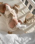 Baby wearing white lace ruffle knee-high cotton crochet socks with soft breathable comfort for newborns and toddlers
