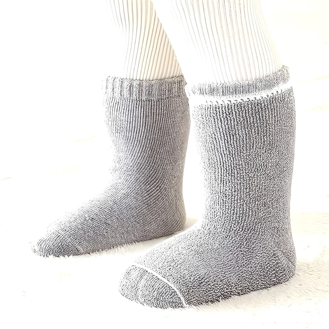 Child wearing thick grey cotton socks for winter warmth and comfort