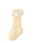 Delicate yellow lace trim baby socks for girls, breathable cotton knit.